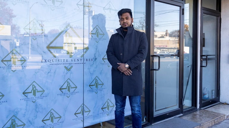 Sadiqur Rahman stands in front of his business that was...