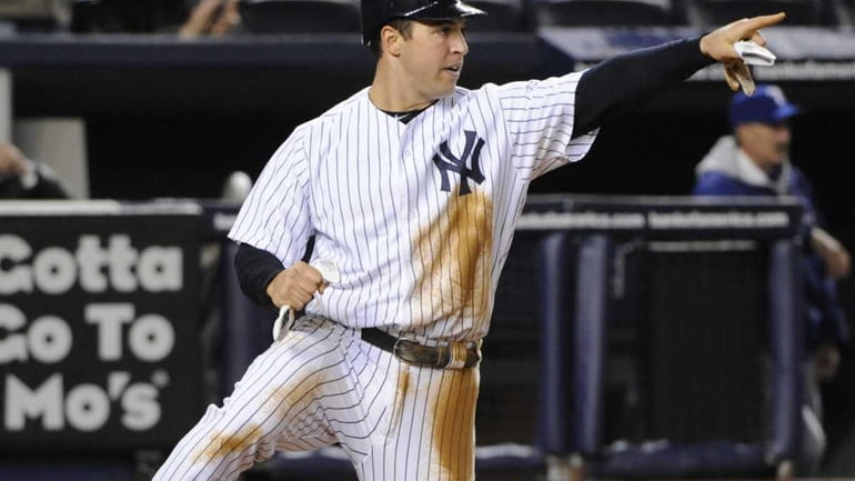 New York Yankees' Mark Teixeira points to Eric Chavez after...