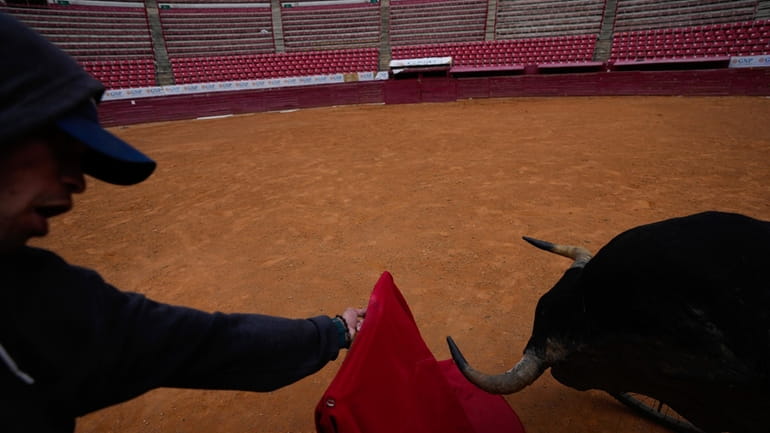 A bullfighter practices at the Plaza de Toros Mexico bullring...