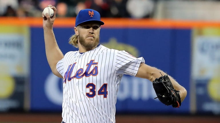Mets starting pitcher Noah Syndergaard (34) delivers a pitch during...