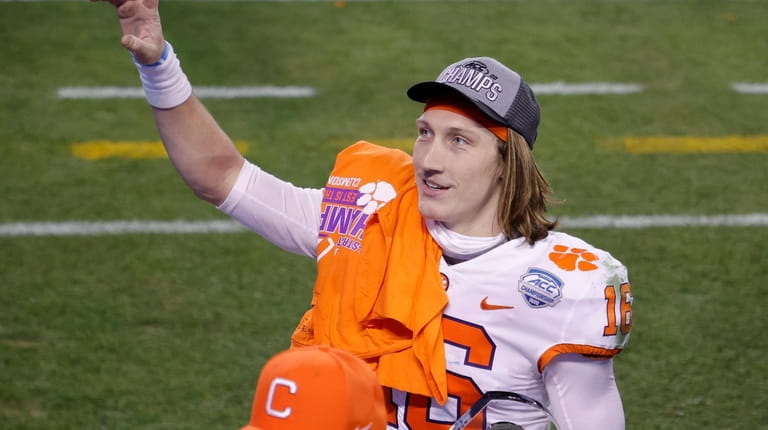 Trevor Lawrence  of the Clemson Tigers acknowledges fans as he...