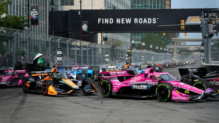 The field makes a turn during the IndyCar Detroit Grand...