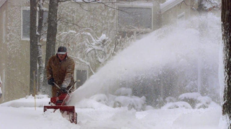 Kevin McGrath clears his driveway in Northport. (2000)