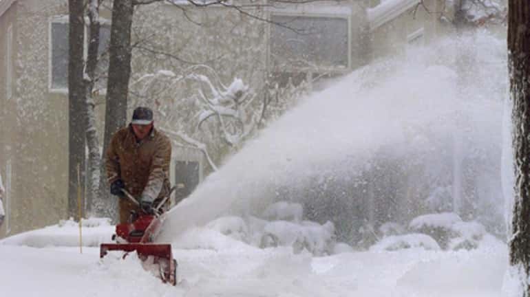 Kevin McGrath clears his driveway in Northport. (2000)