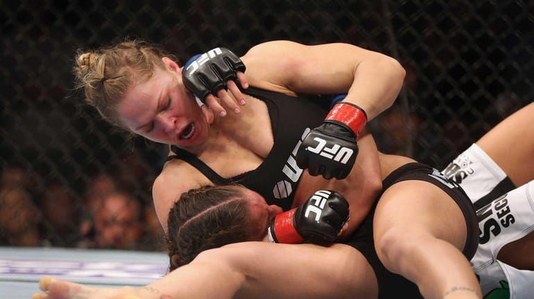 Ronda Rousey hits Liz Carmouche during their UFC bantamweight title...