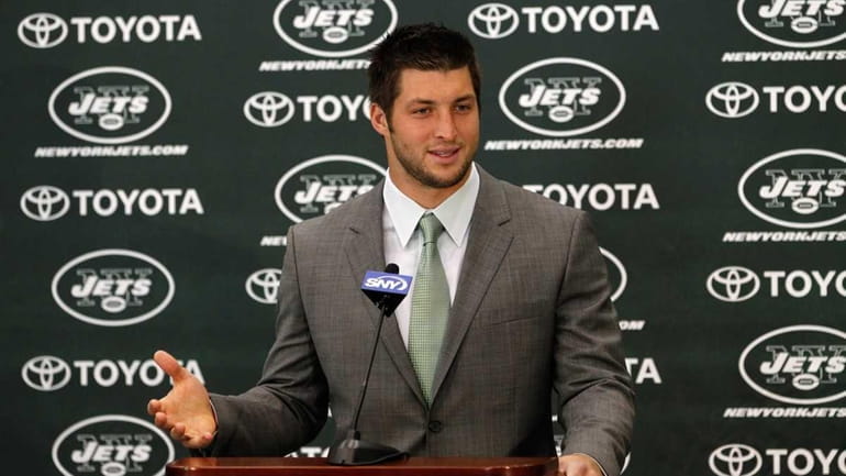 Tim Tebow addresses the media as he is introduced as...