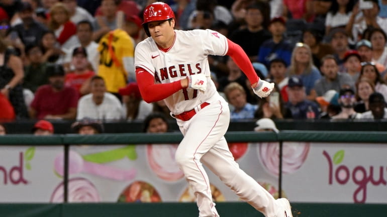 Los Angeles Angels' Shohei Ohtani runs toward second but is...