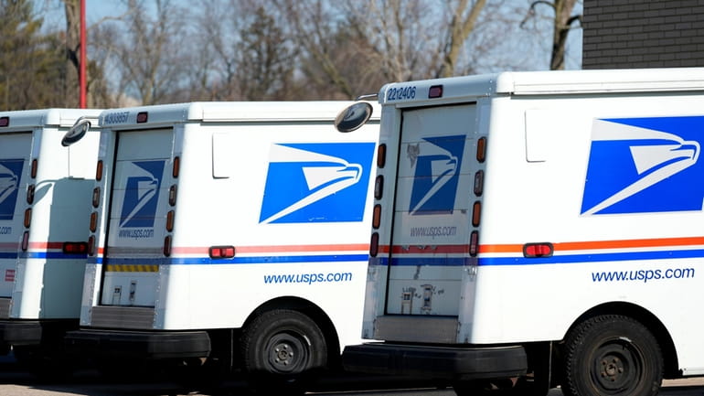 U.S. Postal Service trucks park outside a post office, Jan....