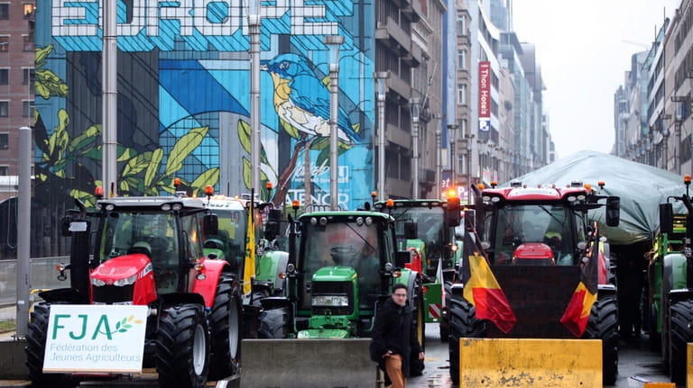 Tractors are parked behind a blockade in the European Quarter...