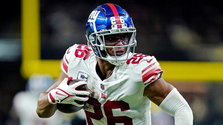 Giants running back Saquon Barkley carries in the second half of...