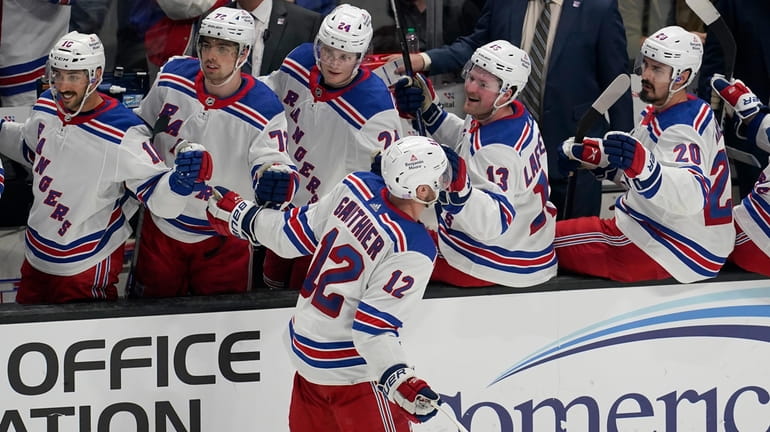 Rangers right wing Julien Gauthier is congratulated after scoring against the Sharks...