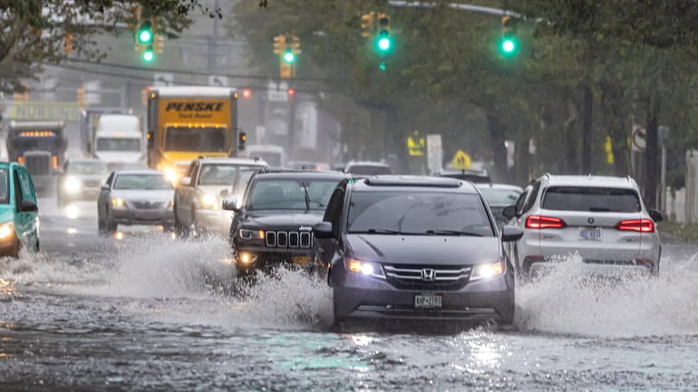 Traffic on the flooded Peninsula Boulevard in Woodmere Friday.