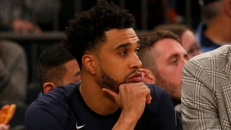 The Knicks' Courtney Lee looks on from the bench during a...