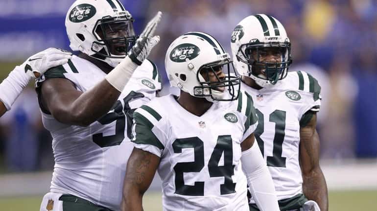 Darrelle Revis #24 of the New York Jets celebrates after...
