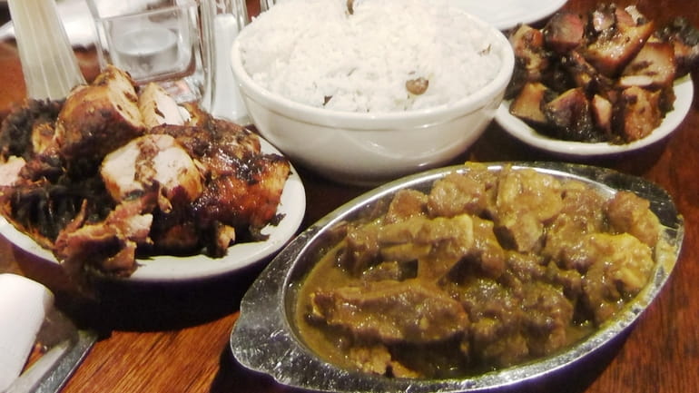 Curried goat, jerk chicken, rice and peas and jerk pork...