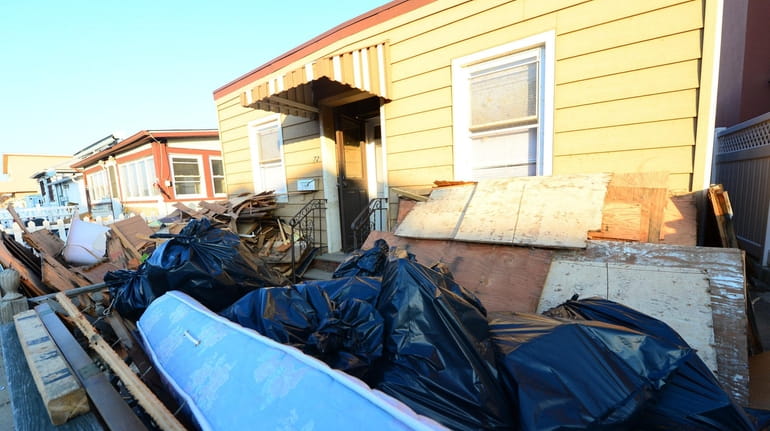 Unoccupied homes on Long Beach, shown in 2013, that were...
