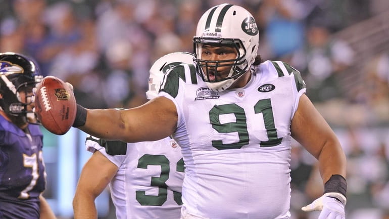 The Jets' Sione Pouha celebrates his fumble recovery on the...