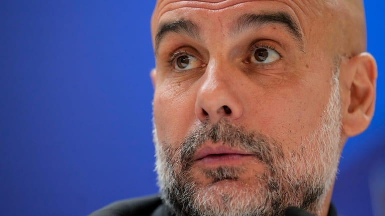 Manchester City's head coach Pep Guardiola attends a press conference...