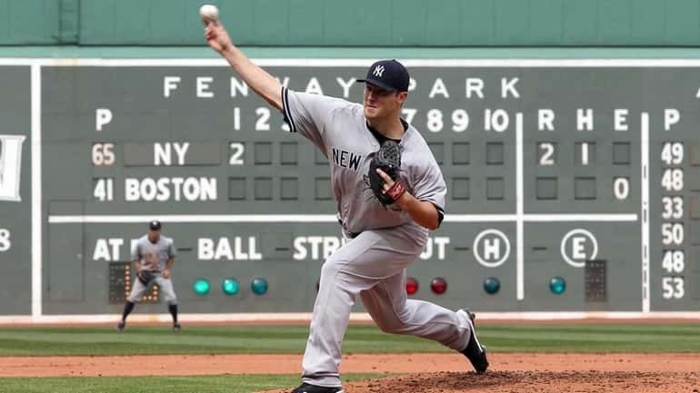 Yankees starter Phil Hughes throws against the Red Sox in...