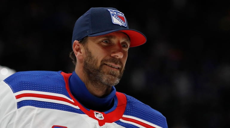 Henrik Lundqvist skates off the ice after a game against...