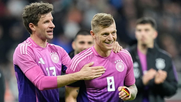 Germany's Thomas Muller, left, and Germany's Toni Kroos smile after...