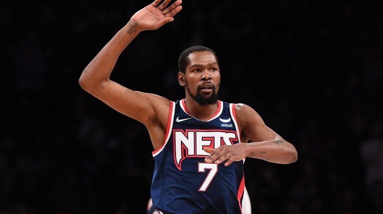 Brooklyn Nets forward Kevin Durant reacts after sinking a three-point...
