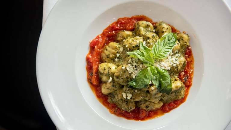 Gnocchi tossed in pesto on a bed of tomato sauce...