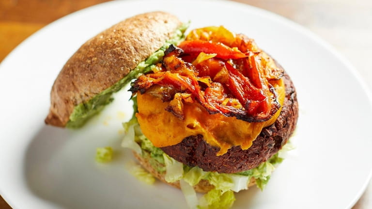 The "dirty" beet burger with sauteed onions and peppers, guacamole and...