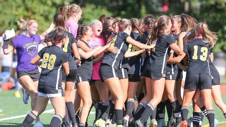 Commack celebrates their overtime win over Northport in a Suffolk...