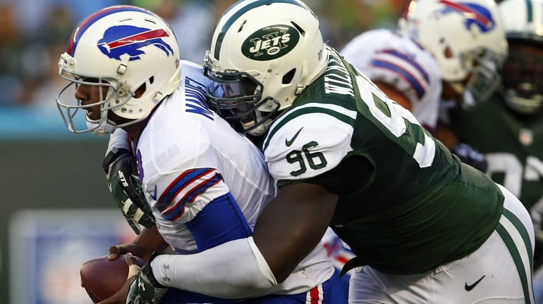Jets defensive end Muhammad Wilkerson sacks Bills quarterback E.J. Manuel...