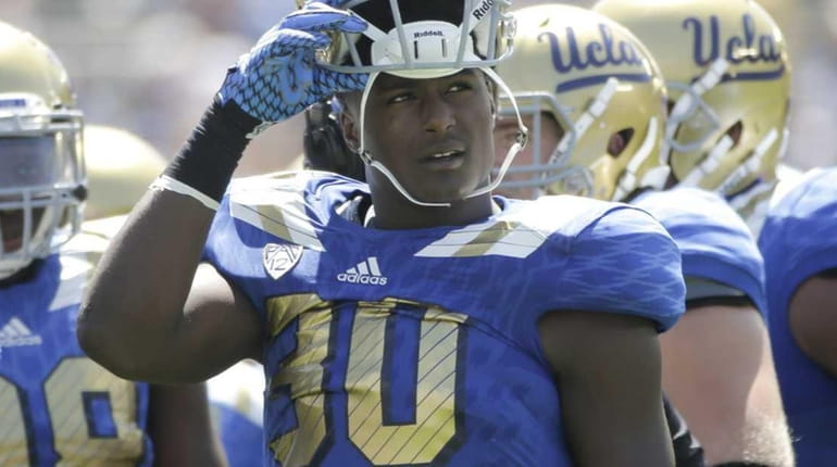 UCLA linebacker Myles Jack, center, looks away during the first...