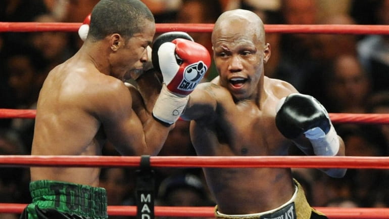 Zab Judah, right, lands a punch on Ernest Johnson during...