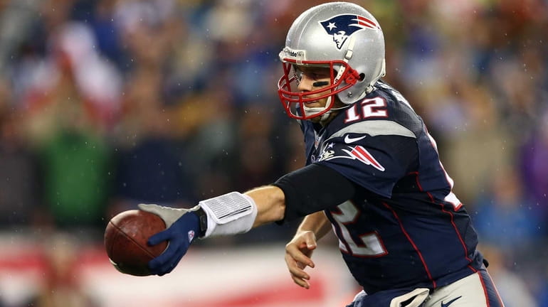 New England Patriots quarterback Tom Brady hands off the ball...