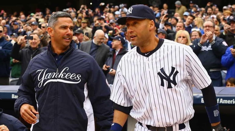 Jorge Posada, left, and Derek Jeter are introduced before the...