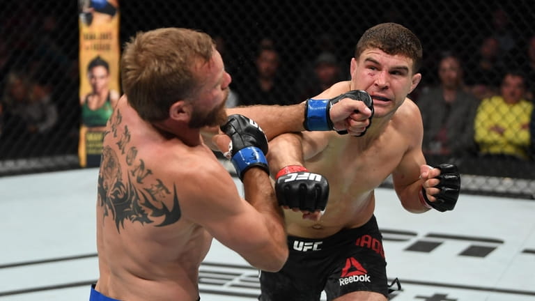 Al Iaquinta, right, punches Donald Cerrone in their lightweight bout...