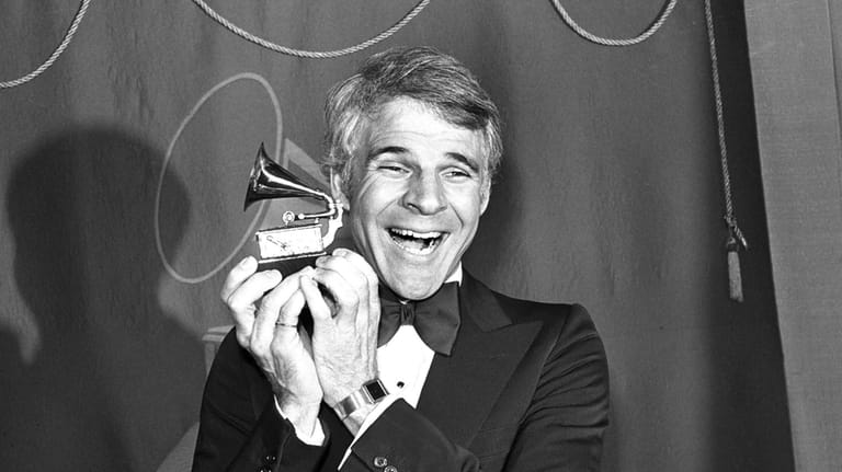 Comedian Steve Martin holds the Grammy Award which he won...