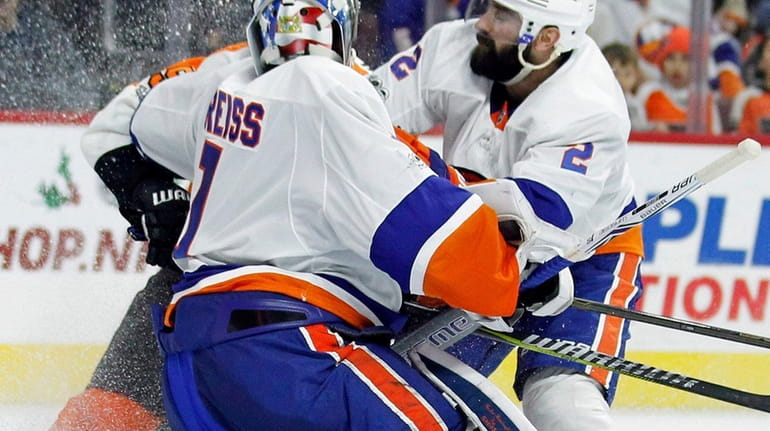New York Islanders' Nick Leddy, right, drives Philadelphia Flyers' Valtteri...