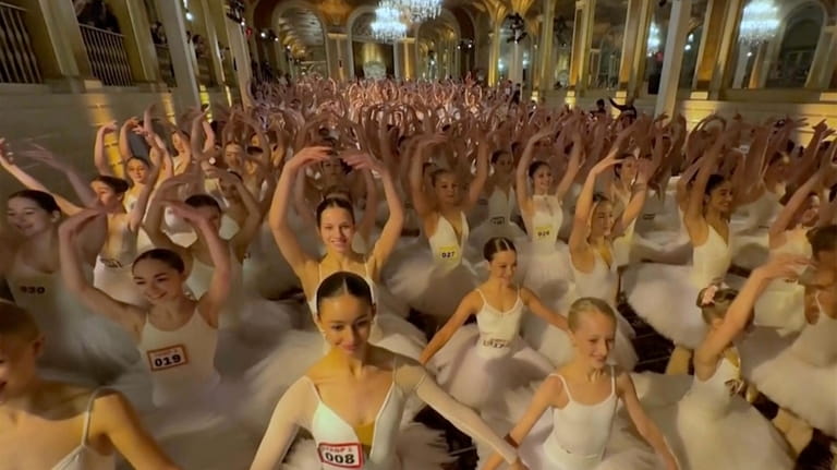 This image taken from video shows hundreds of young dancers...