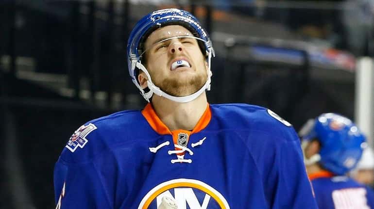 Ryan Pulock #6 of the New York Islanders reacts after...