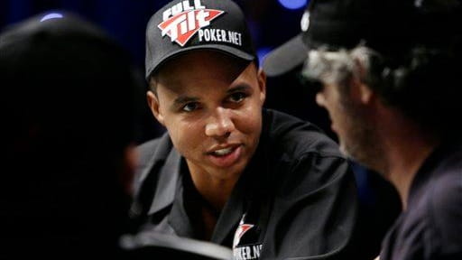 Phil Ivey talks to other players during the World Series...