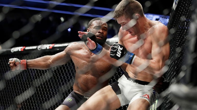 Tyron Woodley, left, takes a swing at Stephen Thompson in...