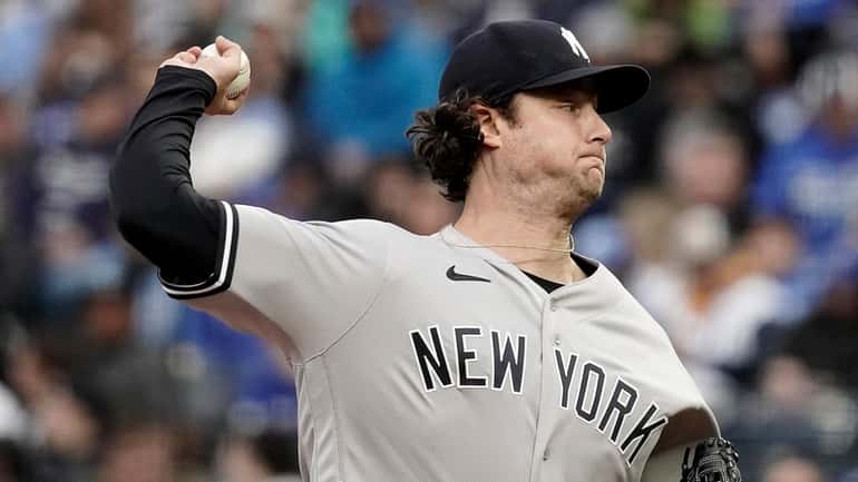Yankees starting pitcher Gerrit Cole throws against the Kansas City...