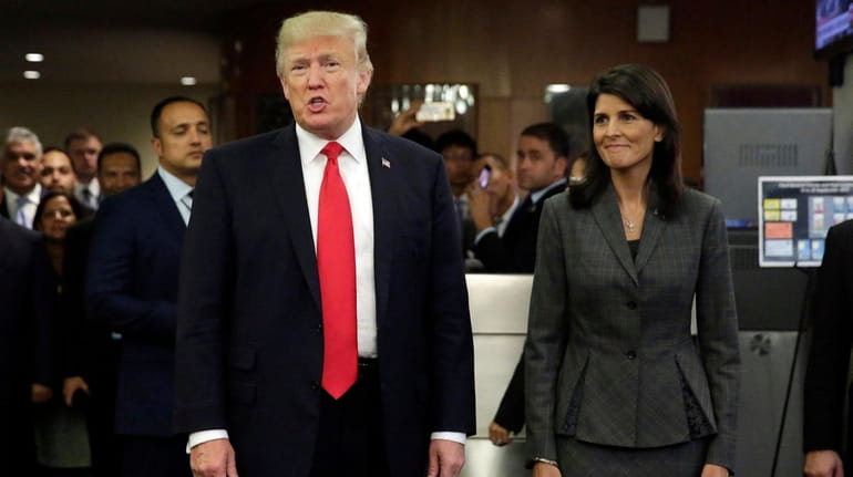 President Donald Trump, accompanied by U.S. Ambassador to the UN...