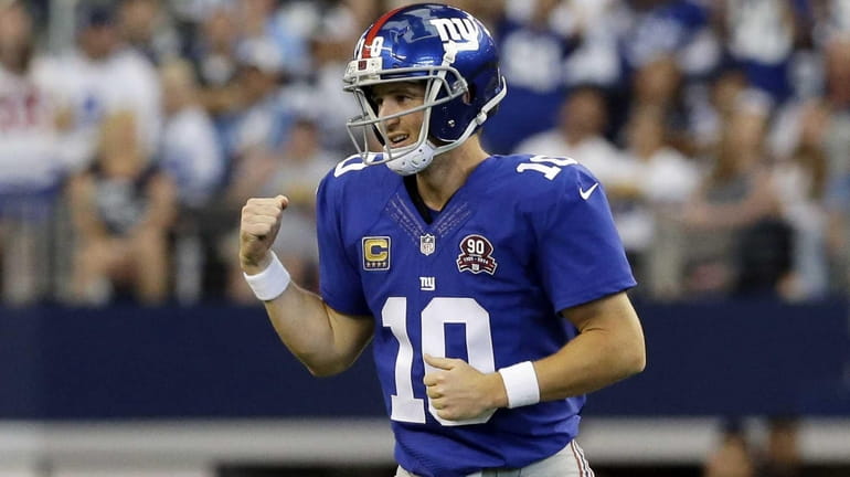 Giants quarterback Eli Manning celebrates after completing a touchdown pass...