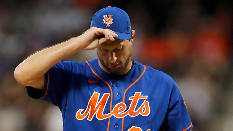 Max Scherzer of the Mets reacts on the mound during the first...