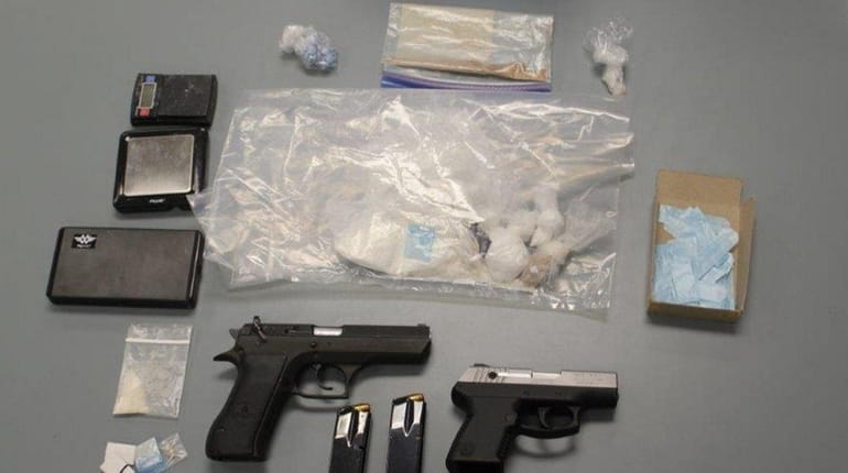 Nassau County police officials say they seized guns and drugs...