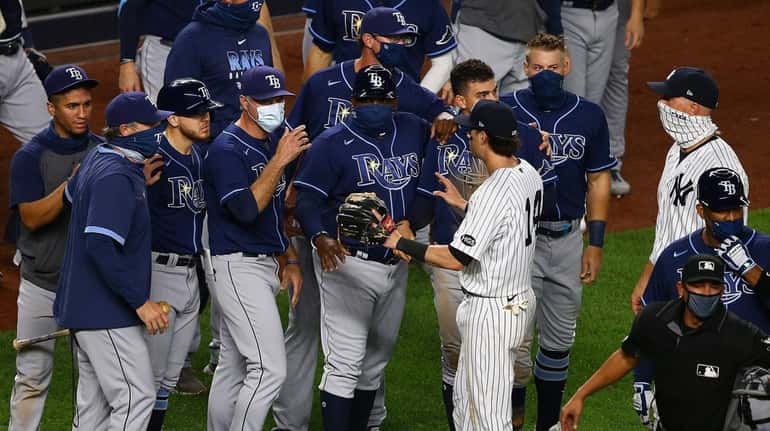 Members of the Yankees and the Rays exchange words after the...