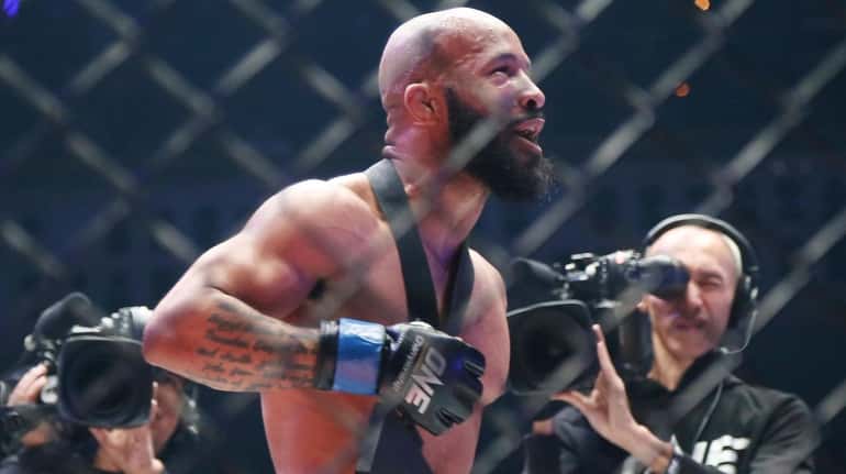 Mixed martial arts fighter Demetrious Johnson of the United States celebrates after...