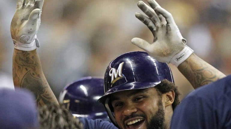 Milwaukee Brewers' Prince Fielder reacts in the dugout after his...