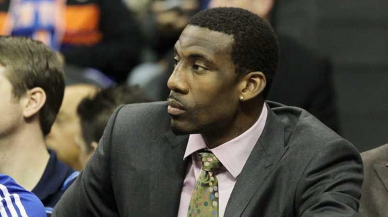 Amar'e Stoudemire #1 of the New York Knicks looks on...